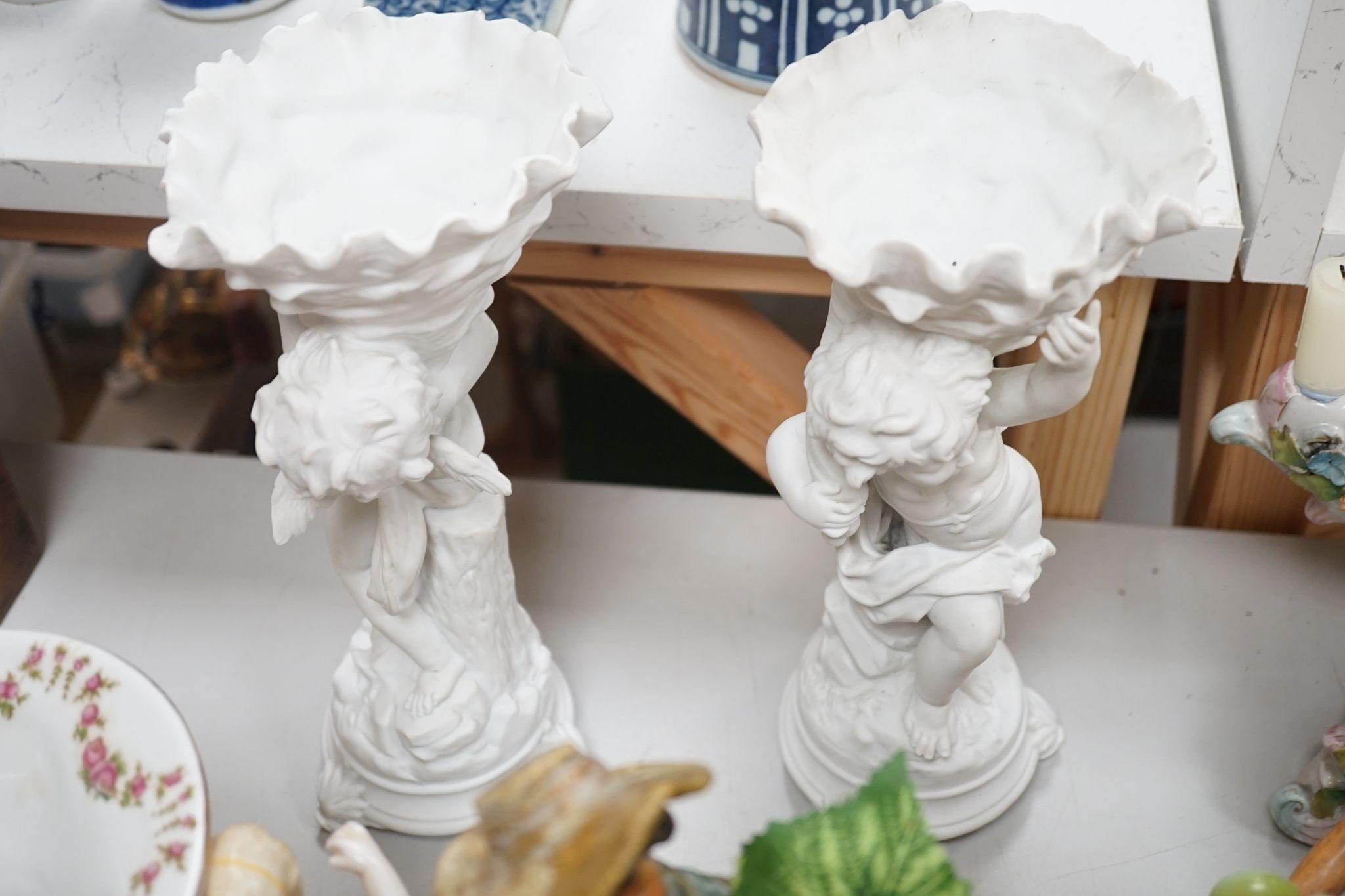 A group of Continental porcelain and pottery figural vases and centrepieces and two candelabra